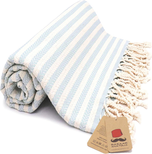 Light Blue Arpa Turkish cotton beach towel with woven stripes and tasseled ends.
