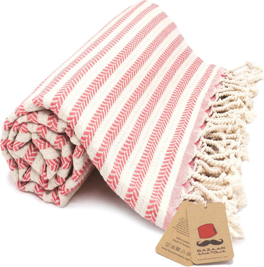 Coral Arpa Turkish cotton beach towel with woven stripes and tasseled ends.