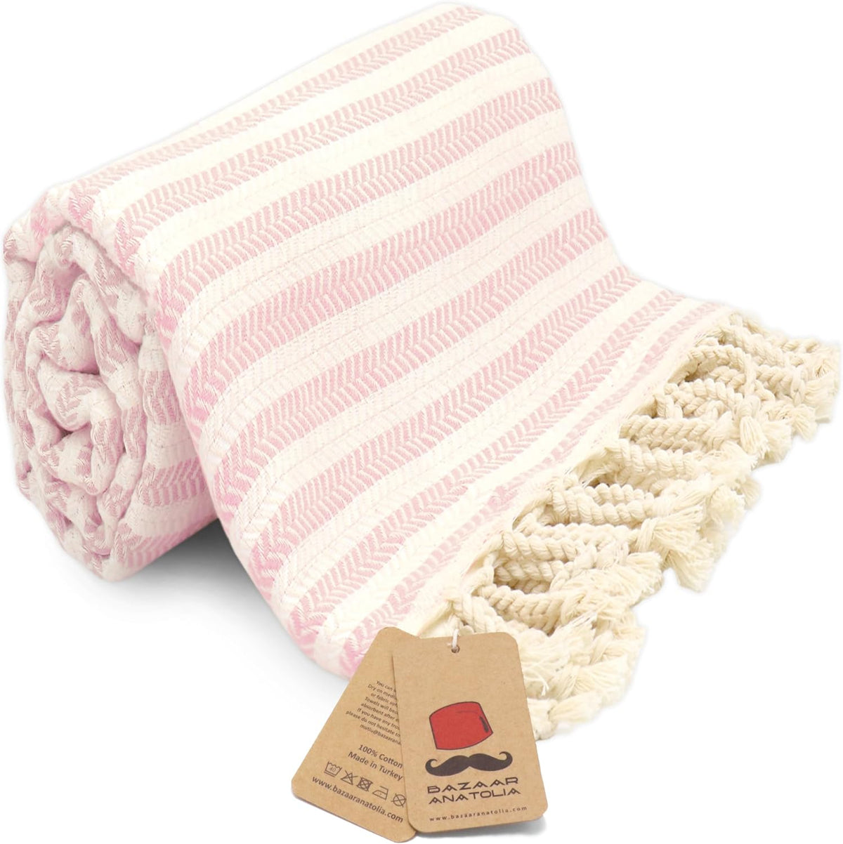 Pink Arpa Turkish cotton beach towel with woven stripes and tasseled ends.