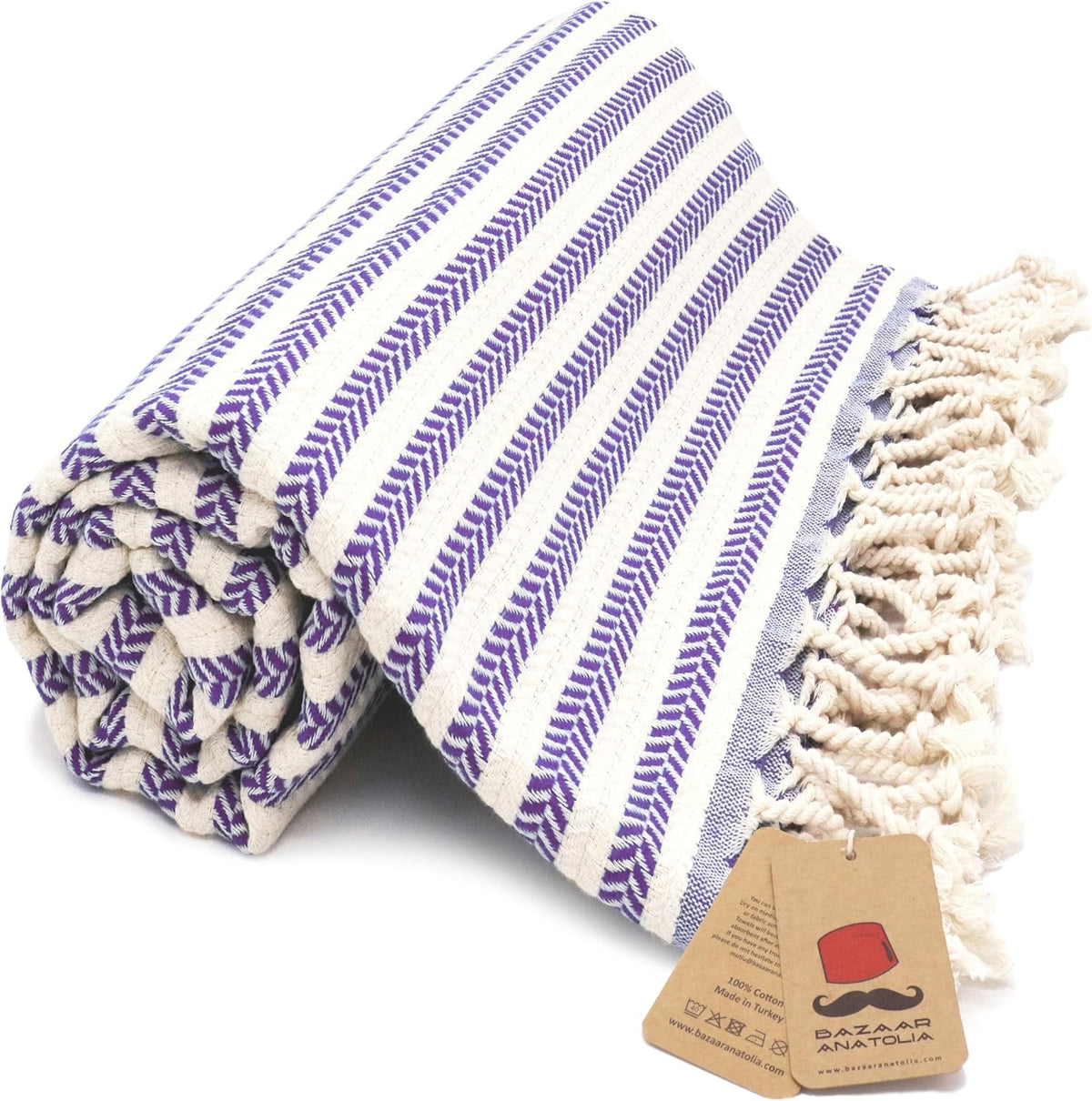 Purple Arpa Turkish cotton beach towel with woven stripes and tasseled ends.