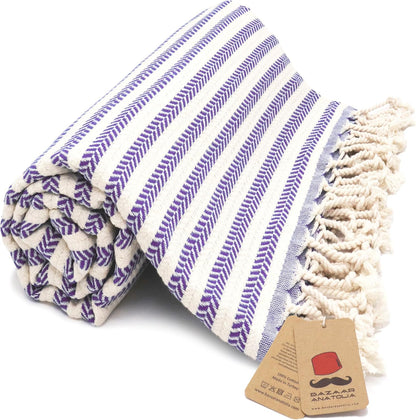 Purple Arpa Turkish cotton beach towel with woven stripes and tasseled ends.