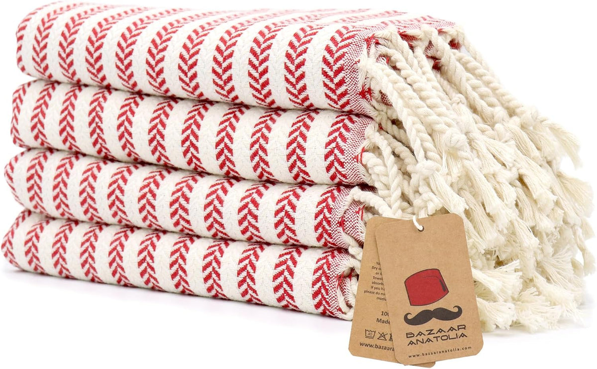 Set of four red Arpa Turkish cotton hand towels with tasseled ends.