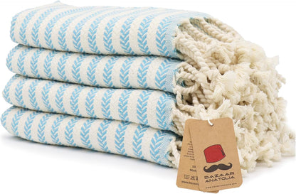 Set of four turquoise Arpa Turkish cotton hand towels with tasseled ends.