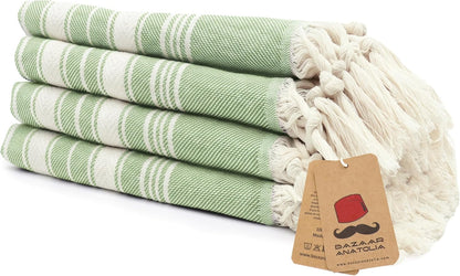 Set of four green Stripe Turkish cotton hand towels with tasseled ends.