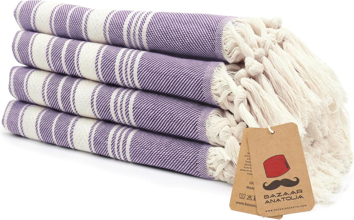 Set of four purple Stripe Turkish cotton hand towels with tasseled ends.