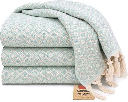 Set of four mint Ethnic Turkish cotton hand towels with tasseled ends.