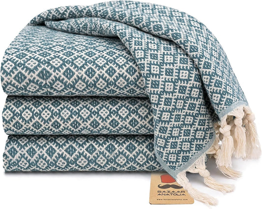Set of four teal Ethnic Turkish cotton hand towels with tasseled ends.